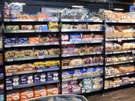 Inflation falls to lowest rate in eight months A bread and bakery section inside of a convenience store.