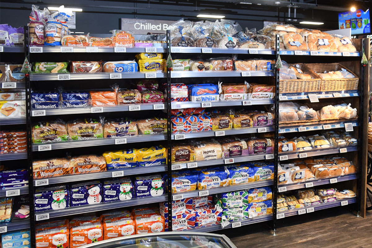 A bread and bakery section inside of a convenience store.