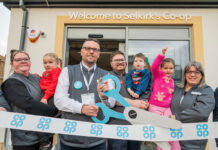 Co-op opens four new stores across Scotland A group of people open Co-op Selkirk using novelty scissors to cut a Co-op branded ribbon.