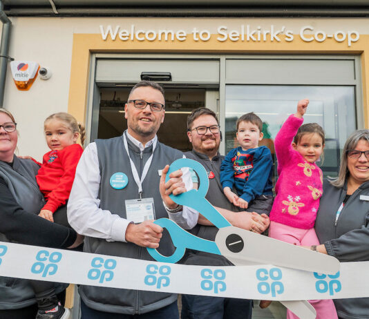 Co-op opens four new stores across Scotland A group of people open Co-op Selkirk using novelty scissors to cut a Co-op branded ribbon.