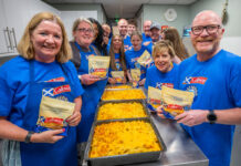 Galloway Gathering project donates over 90,000 meals A group of people, including Scotland's national chef Gary Maclean, stand together in a kitchen with trays of macaroni cheese on the table.