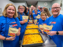 Galloway Gathering project donates over 90,000 meals A group of people, including Scotland's national chef Gary Maclean, stand together in a kitchen with trays of macaroni cheese on the table.