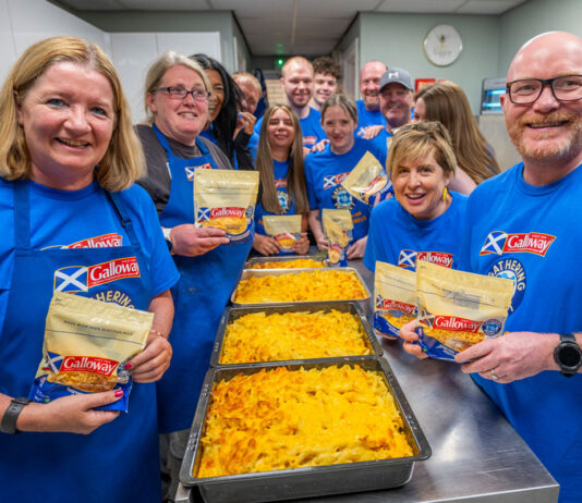 Galloway Gathering project donates over 90,000 meals A group of people, including Scotland's national chef Gary Maclean, stand together in a kitchen with trays of macaroni cheese on the table.