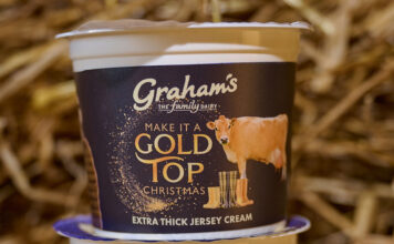 Graham’s Gold Top Jersey Cream is back on the shelves A pack of Graham's Gold Top Extra Thick Jersey Cream stands on top of another pack in a barn with straw behind it.