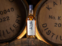 Hatozaki Japanese whisky launches Triple Cask Reserve dram A bottle of Hatozaki Whisky Triple Cask Reserve is balanced on a wooden cask with wooden casks behind this.