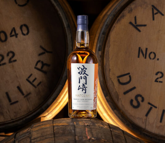 Hatozaki Japanese whisky launches Triple Cask Reserve dram A bottle of Hatozaki Whisky Triple Cask Reserve is balanced on a wooden cask with wooden casks behind this.