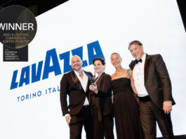 Lavazza named best Commercial Coffee Roaster for third year running A group of people accept the Best European Commercial Coffee Roaster award for Lavazza with the coffee brand's logo on the screen behind the group and the logo for the award in the corner.