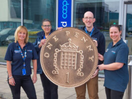 Scotmid rolls out Pennies round up for Alzheimer Scotland support Members of the Scotmid team stand together holding a novelty sized penny coin in front of the firm's headquarters.