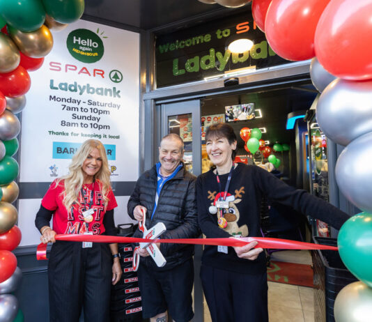 Spar Market Ladybank opens its doors following major investment A group of people stand at the entrance to Spar Market Ladybank whilst cutting a ribbon with a novelty pair of scissors.