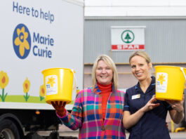Spar Scotland hits record-breaking fundraising for charity Two staff members stands the Spar Scotland wholesale depot holding fundraising buckets for Marie Curie with the charity's branded van behind them.