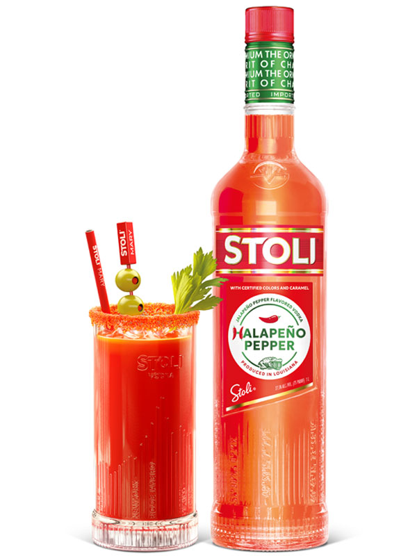 A bottle of Stoli Halapeño Pepper vodka bottle next to a Bloody Mary cocktail serve.
