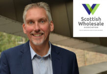 Scottish Wholesale Association unveils new website Colin Smith, chief executive at the Scottish Wholesale Association, with the logo for the organisation in the top right hand corner in a white box.