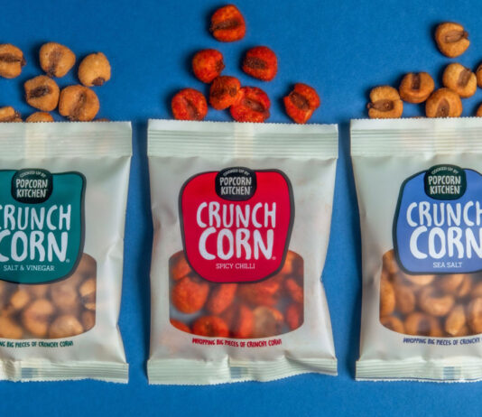 Popcorn Kitchen goes savoury with new Crunch Corn Pack of Popcorn Kitchen Crunch Corn lay open on a blue background with pieces of the corn spilled out from the top of the packs.