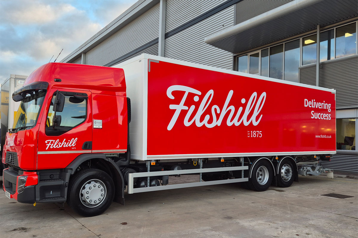 A JW Filshill red HGV stands outside its depot in Renfrewshire.