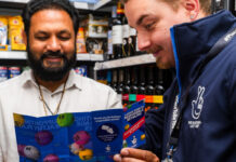 National Lottery retailers set new record for age-verification A representative of the National Lottery shows a retailers a pamphlet for the National Lottery inside his store.