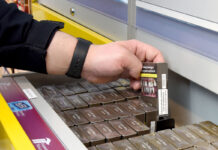 Inflation creeps upwards at end of 2025 A person is lifting out a pack of cigarettes from a drawer at the back of a shop.