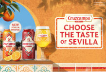 Cruzcampo introduces Sevilla Orange beer flavour Promotional image of Cruzcampo Sevilla Orange launch featuring a can of the new beer and classic Cruzcampo sitting on a windowsill on a wall.