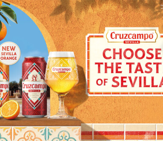 Cruzcampo introduces Sevilla Orange beer flavour Promotional image of Cruzcampo Sevilla Orange launch featuring a can of the new beer and classic Cruzcampo sitting on a windowsill on a wall.