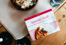 GSN expands its Signature ready meal range A pack of GSN Signature Meal Firecracker Salmon & Jasmine Rice sits on a table with the meal plated up next to it.