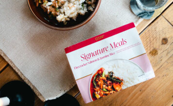 GSN expands its Signature ready meal range A pack of GSN Signature Meal Firecracker Salmon & Jasmine Rice sits on a table with the meal plated up next to it.