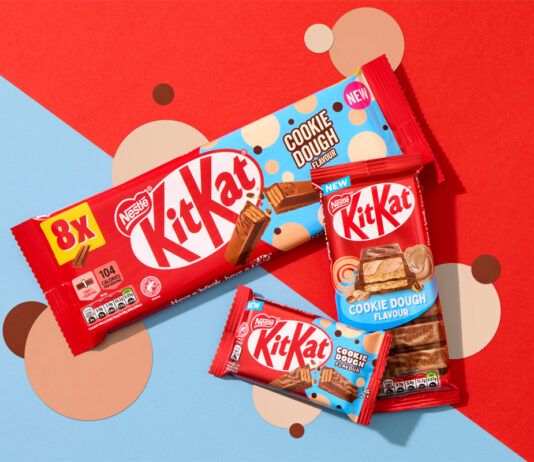 KitKat introduces new Cookie Dough flavour across range Packs of KitKat Cookie Dough formats sit across a red and blue background with beige and brown coloured dots as part of the background design.
