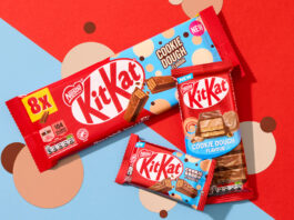 KitKat introduces new Cookie Dough flavour across range Packs of KitKat Cookie Dough formats sit across a red and blue background with beige and brown coloured dots as part of the background design.
