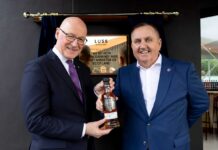 First Minister opens Luss Distillery First Minister John Swinney receives a bespoke bottle of whisky from Loch Lomond Group chief executive Colin Matthews.