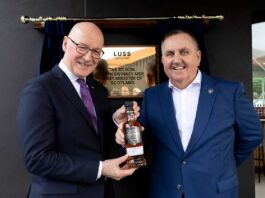 First Minister opens Luss Distillery First Minister John Swinney receives a bespoke bottle of whisky from Loch Lomond Group chief executive Colin Matthews.