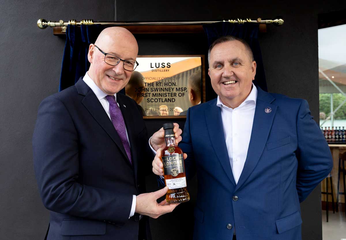 First Minister John Swinney receives a bespoke bottle of whisky from Loch Lomond Group chief executive Colin Matthews.