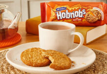 McVitie’s and PG Tips take a tea break A plate with a cup of tea and HobNob biscuits on it are in the foreground with a packet of McVitie's Hobnobs in the background and a glass teapot next to the plate.