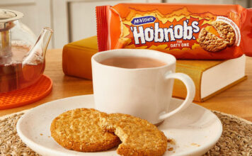 McVitie’s and PG Tips take a tea break A plate with a cup of tea and HobNob biscuits on it are in the foreground with a packet of McVitie's Hobnobs in the background and a glass teapot next to the plate.
