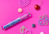 Mentos builds impulse sales with Feeling Berry Good single pack Promotional image of launch for Mentos Feeling Berry Good single pack format launch with pack of the sweets with neon signs of fruit with pieces of fruit against a pink background.