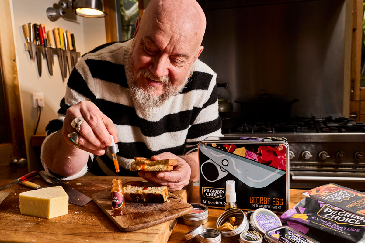 George Egg, also known as the Snack Hacker, adds hot sauce to his cheese toastie.