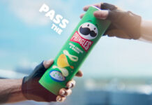 Pringles launches new marketing platform focused on sharing A person passes a tube of Pringles Sour Cream & Onion to another person.
