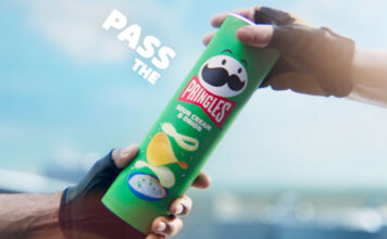 Pringles unveils new marketing platform focused on sharing A person passes a tube of Pringles Sour Cream & Onion to another person.