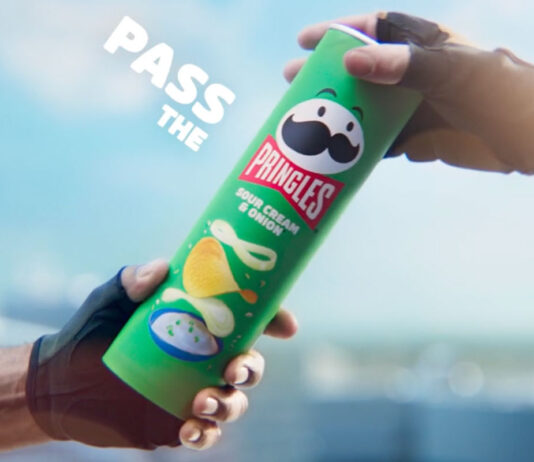 Pringles unveils new marketing platform focused on sharing A person passes a tube of Pringles Sour Cream & Onion to another person.