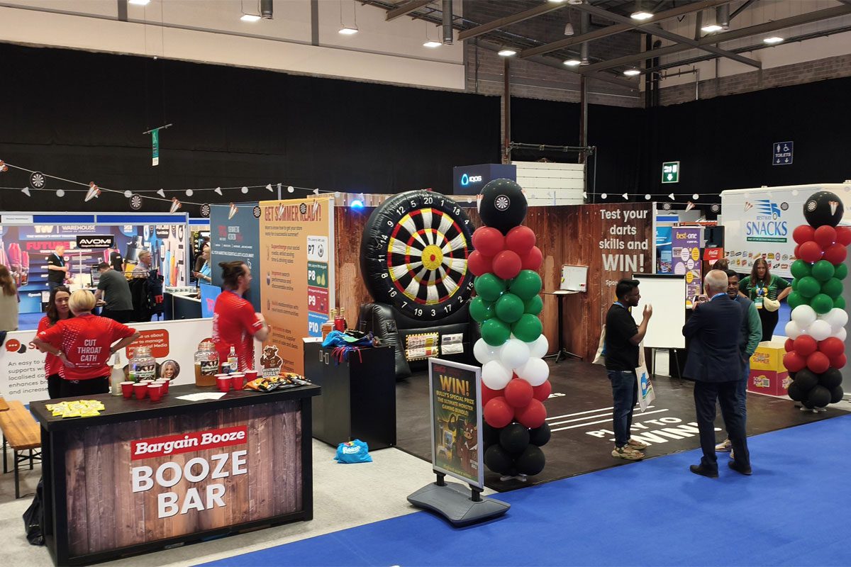 Photo of the floor of the Bestway Retail Showcase with stands and people walking across the floor.