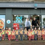 Co-op store reopens in Tarbert A group of kids are lined up outside Co-op Tarbert to mark the store's reopening.