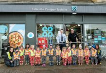 Co-op store reopens in Tarbert A group of kids are lined up outside Co-op Tarbert to mark the store's reopening.