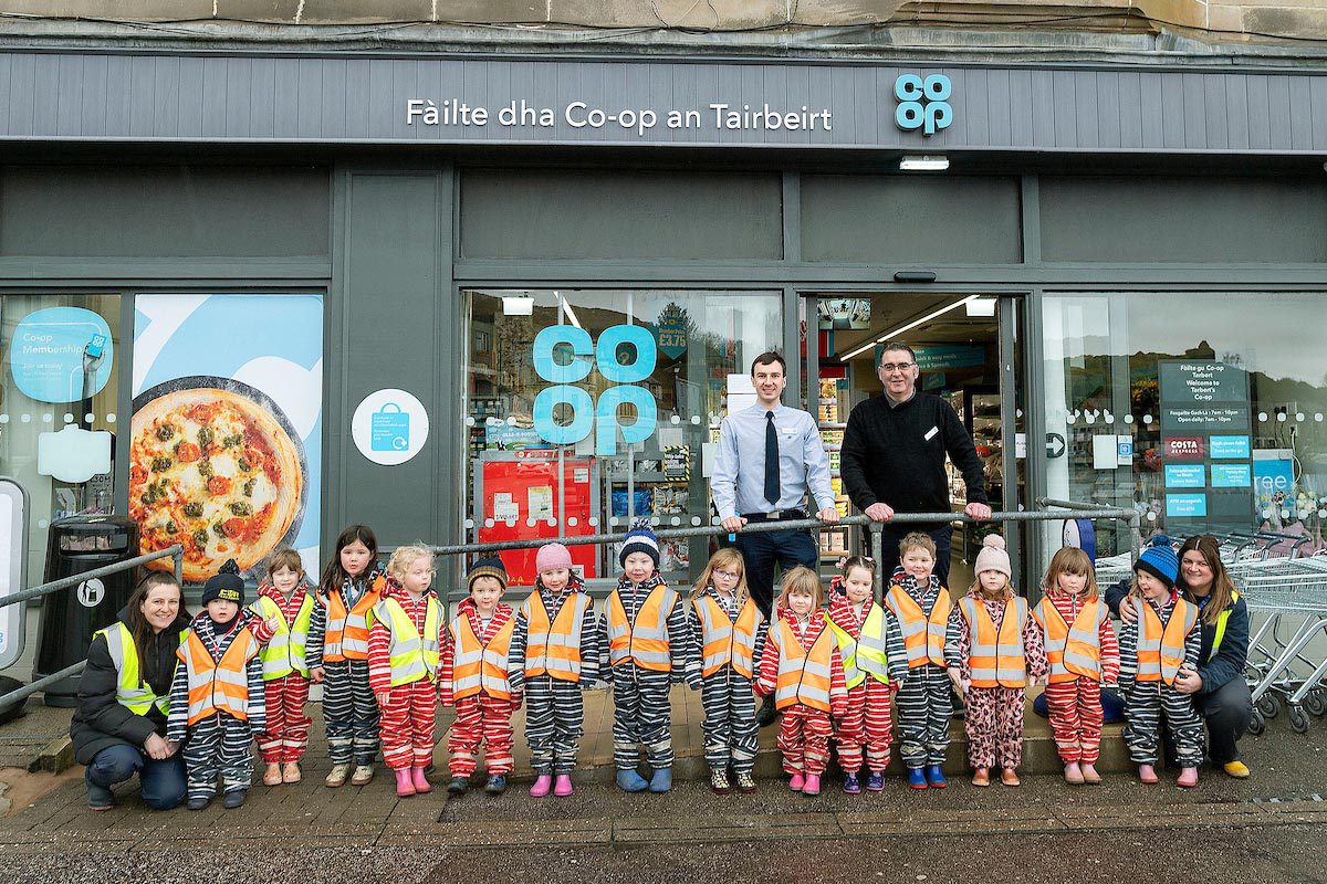 A group of kids are lined up outside Co-op Tarbert to mark the store's reopening.