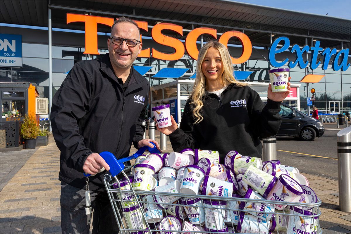 Alex Equi and David Equi stand outside a Tesco Extra store with trolley full of Equis ice cream variants.