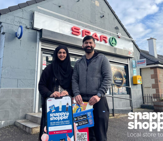 Retail Game Changers: Snappy Shopper Asiyah and Jawad Javed, store owners of Spar Alloa Road, stand outside their store with the Snappy Shopper logo in the bottom right corner.
