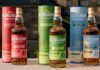 Glencadam unveils packaging rebrand for wine cask range Bottles of Glencadam's new design along with their outer packs are lined up on a wall.