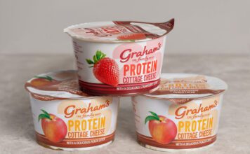 Graham’s introduces new Cottage Cheese with Fruit Layers Pots of Graham's The Family Dairy's Cottage Cheese with Fruit Layers have been stacked up in a pyramid formation against a grey background.