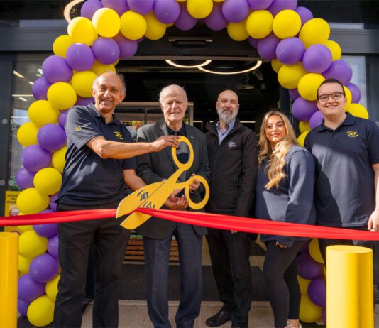 Jet Restalrig reopens following six-month transformation A group of people open Jet Restalrig in Edinburgh using a pair of novelty scissors to cut a ribbon.