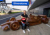 KitKat revs up for F1 season with life-sized chocolate car Billy Monger, former F1 driver, sits in front of a life-sized chocolate F1 car with the KitKat logo on it and the starting line of Silverstone Circuit.