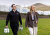 Mills Milk targets further expansion after £24m turnover result Members of the Mills Milk team stand in a field with branded vans behind them and a hill in the distance.