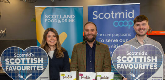 Nudie Snacks crisps range hits Scotmid shelves Lauren Rafferty, commercial development coordinator at Scotmid, Rodney Graham, managing director at Nudie Snacks and Steve Addison, local sourcing manager at Scotmid, all stand at a table for the Scottish Favourites competition with packs of Nudie Snacks sweet potato crisps.