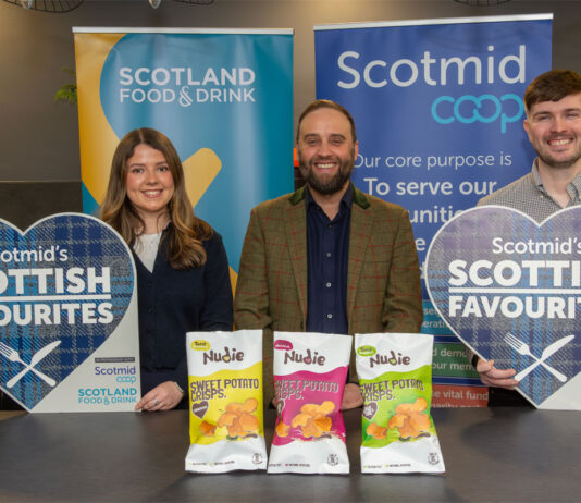 Nudie Snacks crisps range hits Scotmid shelves Lauren Rafferty, commercial development coordinator at Scotmid, Rodney Graham, managing director at Nudie Snacks and Steve Addison, local sourcing manager at Scotmid, all stand at a table for the Scottish Favourites competition with packs of Nudie Snacks sweet potato crisps.