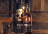 Smokehead capitalises on barbecue season with new campaign A bottle and outer box of Smokehead whisky stand on a table.